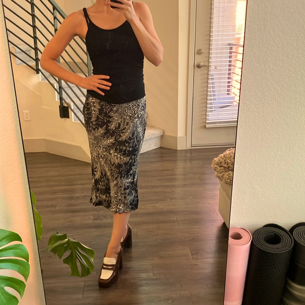 Anthropologie midi silk skirt with small kick flare, navy with white floral.